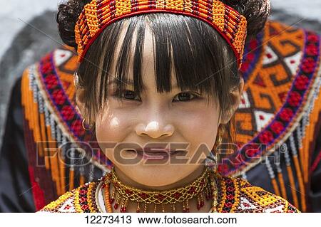 Girl in traditional Torajan dress attending a funeral ceremony at a rante, the ceremonial site for a Torajan funeral, in Sereale, Toraja Land, South Sulawesi, Indonesia View Large Photo Image Stock Image - Girl in traditional Torajan dress attending a funeral ceremony at a rante, the ceremonial site for a Torajan funeral, in Sereale, Toraja Land, South Sulawesi, Indonesia. Fotosearch