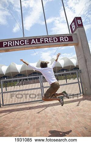 Stock Photography - Girl Jumping at Port Elizabeth World Cup Stadium, Scenes at 2010 Stadium, Port Elizabeth, Garden Route, South Africa,.. Fotosearch