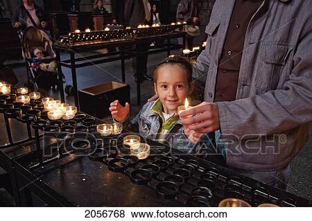 Girl Lighting Votive Candles In The Cologne Cathedral, Cologne, North Rhine-Westphalia, Germany View Large Photo Image Stock Photo - Girl Lighting Votive Candles In The Cologne Cathedral, Cologne, North Rhine-Westphalia, Germany. Fotosearch