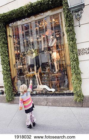 Stock Image - Girl Looking And Display At Bergdorf. Fotosearch
