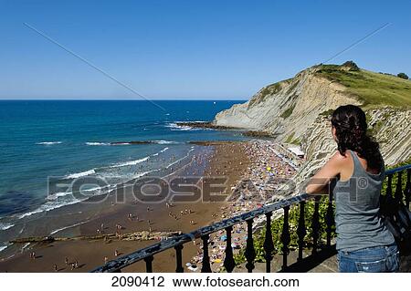 Girl Looking At The View Of Itzurun Beach, Zumaia, Basque Country, Spain View Large Photo Image Stock Image - Girl Looking At The View Of Itzurun Beach, Zumaia, Basque Country, Spain. Fotosearch