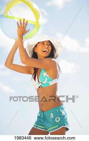 Girl On The Beach With A Beachball. View Large Photo Image Stock Photograph - Girl On The Beach With A Beachball.. Fotosearch