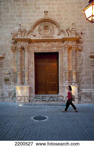 Stock Photo - Girl Passing In Front Of Esglesia Del Roser, A Church In Ciutadella, Menorca, Balearic Islands, Spain. Fotosearch