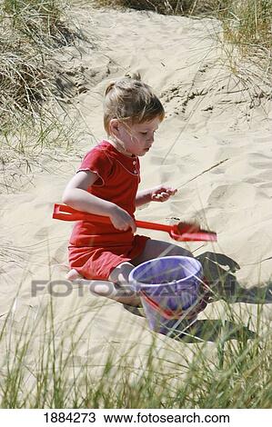 Girl Playing With Bucket And Spade On Sand Dune View Large Photo Image Stock Image - Girl Playing With Bucket And Spade On Sand Dune. Fotosearch