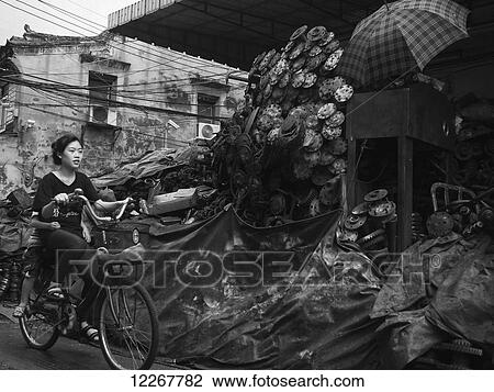 Girl riding a bicycle in Chinatown; Bangkok, Thailand View Large Photo Image Stock Image - Girl riding a bicycle in Chinatown; Bangkok, Thailand. Fotosearch