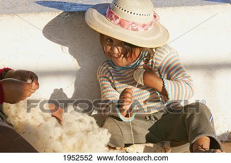 Stock Image - Girl spindling cotton, Sucre, Chuquisaca Department, Bolivia. Fotosearch