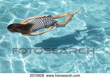 Stock Photo - Girl Swimming Underwater; Ontario Canada. Fotosearch