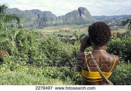 Girl taking photo of Mogote hills, Vinales Valley; Pinar Del Rio, Cuba View Large Photo Image Stock Photo - Girl taking photo of Mogote hills, Vinales Valley; Pinar Del Rio, Cuba. Fotosearch