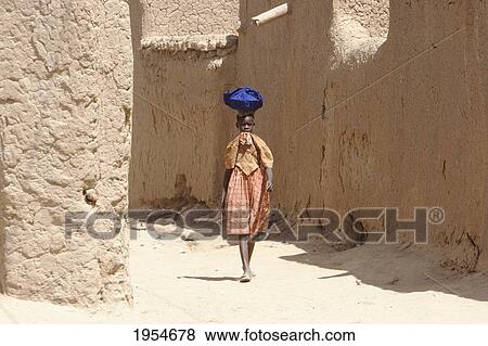 Girl walking on street at Niafunke, Mali View Large Photo Image Stock Photo - Girl walking on street at Niafunke, Mali. Fotosearch