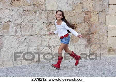Stock Image - Girl Wearing Red Boots, Valletta, Malta. Fotosearch