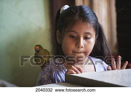 Stock Image - Girl With A Parakeet On Her Shoulder, Concepcion, Santa Cruz Department, Bolivia. Fotosearch