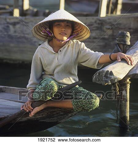 Stock Image - Girl With Conical Hat On Boat. Fotosearch