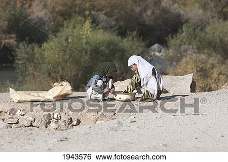 Stock Photograph - Girls By The Side Of The Road In Pol-E Matak, Parwan Province, Afghanistan. Fotosearch