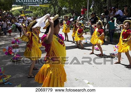 Stock Photo - Girls Dancing Around Festive Baskets In The Entrada De Comadritas Parade During The Carnaval Chapaco, Tarija, Bolivia. Fotosearch