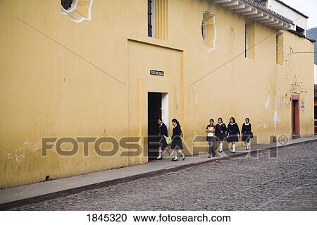 Stock Image - Girls In Uniforms On Their Way To School; Antigua, Guatemala. Fotosearch
