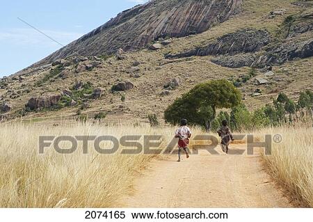 Stock Photography - Girls On A Road Near Anja, Fianarantsoa Province, Madagascar. Fotosearch