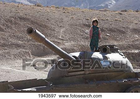 Stock Photo - Girls Playing On An Abandoned Soviet Tank In The Siagerd Valley, Parwan Province, Afghanistan. Fotosearch
