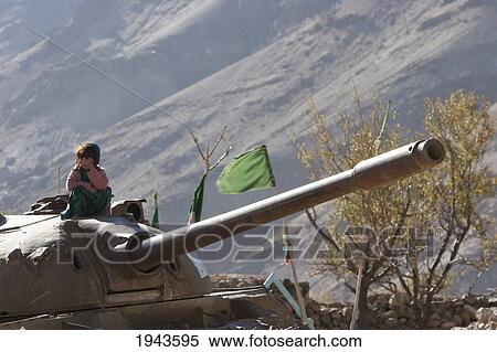 Stock Photography - Girls Playing On An Abandoned Soviet Tank In The Siagerd Valley, Parwan Province, Afghanistan. Fotosearch