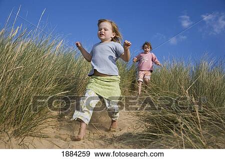 Girls Running Down Sand Dunes View Large Photo Image Stock Photo - Girls Running Down Sand Dunes. Fotosearch