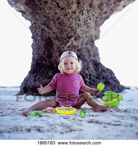 Girls Smiling As She Plays On The Beach With Buckets And Spades View Large Photo Image Stock Image - Girls Smiling As She Plays On The Beach With Buckets And Spades. Fotosearch