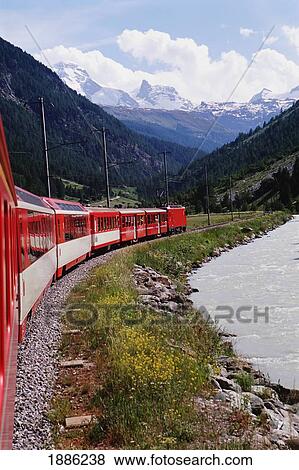 Stock Photo - Glacier Express Train With Alps In Background. Fotosearch