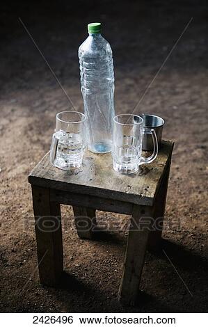 Glasses and a plastic bottle on simple furniture; Ethiopia View Large Photo Image Stock Photograph - Glasses and a plastic bottle on simple furniture; Ethiopia. Fotosearch