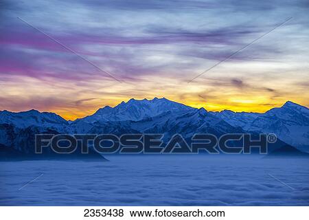 Glowing Sunset Over The Swiss Alps; Locarno, Ticino, Switzerland View Large Photo Image Stock Photo - Glowing Sunset Over The Swiss Alps; Locarno, Ticino, Switzerland. Fotosearch