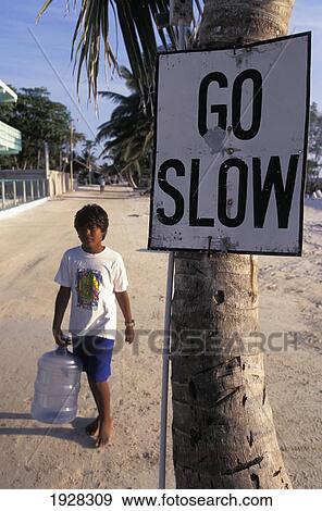 Go Slow Sign With Boy Walking By View Large Photo Image Stock Photo - Go Slow Sign With Boy Walking By. Fotosearch