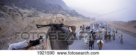 Stock Image - Goat Herder With Ak47 Over Shoulder. Fotosearch