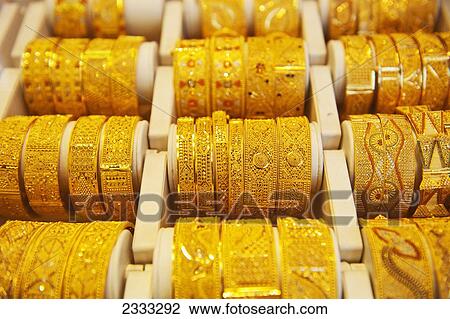 Stock Image - Gold Bangles For Sale In Gold Souk; Dubai, United Arab Emirates. Fotosearch