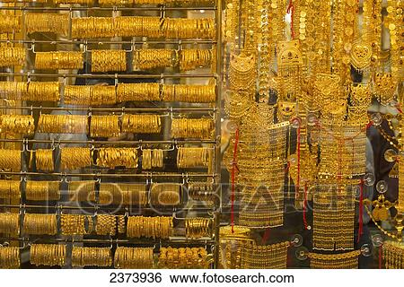 Stock Photograph - Gold jewellery on display in window in the gold souk; Dubai, United Arab Emirates. Fotosearch