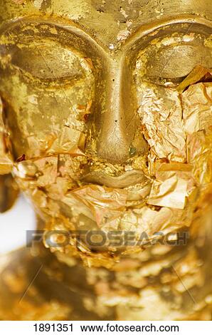 Stock Image - Gold Leaf Offerings On Statue At Wat Phra Kaew Temple. Fotosearch