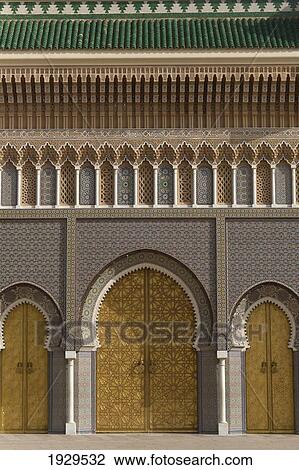 Stock Image - Gold patterned horseshoe shaped doorways on a building; Fez, Morocco. Fotosearch