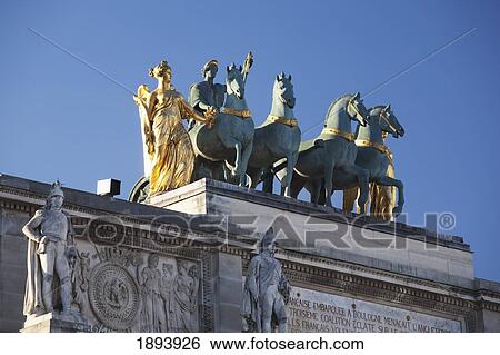 Stock Photograph - Gold Statue With Horses On Top Of The Arc De Triomphe Du Carrousel; Paris, France. Fotosearch