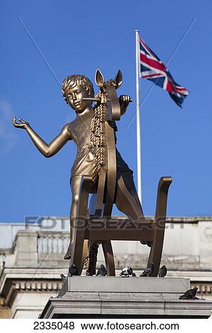 Stock Photo - Golden Boy On Rocking Horse On Top Of Fourth Plinth In Trafalgar Square; London, England, Uk. Fotosearch