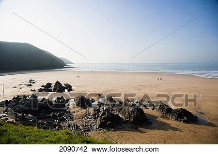 Golden Sand And Rocks On The Beach In Putsborough Sands, North Devon, Uk View Large Photo Image Stock Image - Golden Sand And Rocks On The Beach In Putsborough Sands, North Devon, Uk. Fotosearch