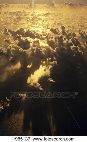Golden Sun Rays Reflecting On Ocean And Puffy Clouds, View From Above. View Large Photo Image Stock Photo - Golden Sun Rays Reflecting On Ocean And Puffy Clouds, View From Above.. Fotosearch