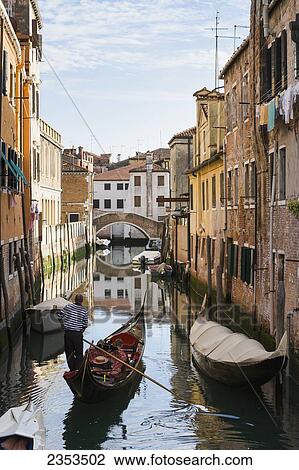 Stock Image - Gondola In A Canal; Venice, Italy. Fotosearch