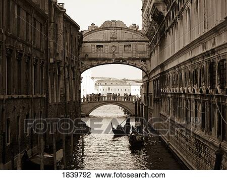 Stock Image - Gondola's Floating Under The Bridge Of Sighs; Venice, Italy. Fotosearch