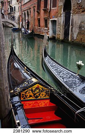 Stock Image - Gondolas in a canal; Venice, Italy. Fotosearch