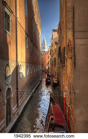 Stock Photography - Gondolas In A Narrow Canal Between Buildings; Venice Italy. Fotosearch