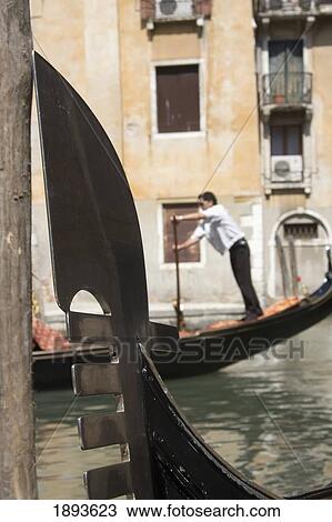 Stock Image - Gondolier And Gondolas In San Marco District. Fotosearch
