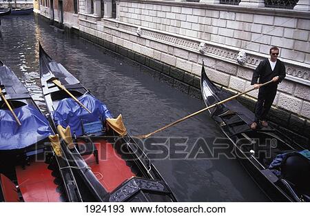 Stock Image - Gondolier And Three Gondolas. Fotosearch