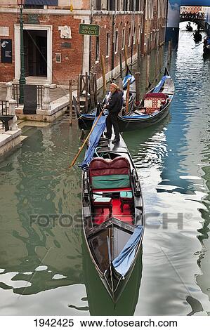 Gondolier On A Gondola In A Canal; Venice Italy View Large Photo Image Stock Photography - Gondolier On A Gondola In A Canal; Venice Italy. Fotosearch