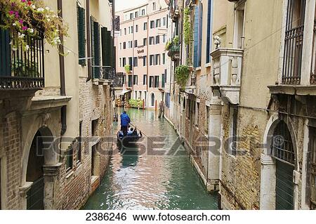 Stock Photograph - Gondolier on canal in Venice; Venice, Veneto, Italy. Fotosearch