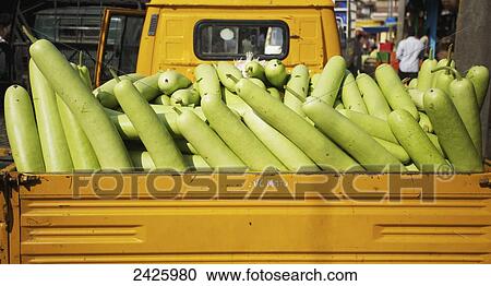 Stock Image - Gourds for sale in the back of a truck at a market; Hyderabad, Andhra Pradesh, India. Fotosearch