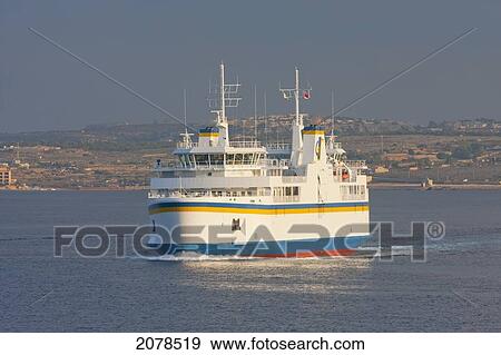 Stock Photo - Gozo Channel Line Ferry Approaching The Harbour, Cirkewwa, Malta. Fotosearch