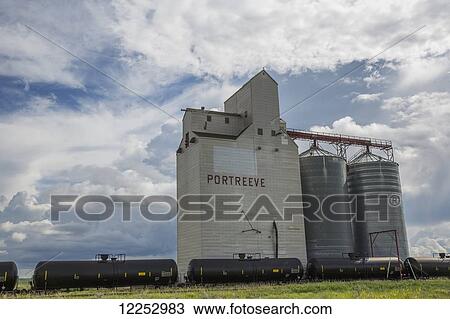 Grain elevator in rural prairies with cumulonimbus clouds building up around it; Saskatchewan, Canada View Large Photo Image Stock Image - Grain elevator in rural prairies with cumulonimbus clouds building up around it; Saskatchewan, Canada. Fotosearch
