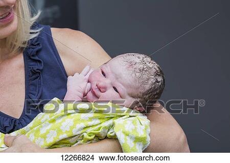 Grandmother holding newborn granddaughter in birthing room; Edmonton, Alberta, Canada View Large Photo Image Picture - Grandmother holding newborn granddaughter in birthing room; Edmonton, Alberta, Canada. Fotosearch