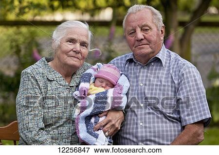 Stock Photo - Grandparents with their newest one month old grandchild; Surrey, British Columbia, Canada. Fotosearch